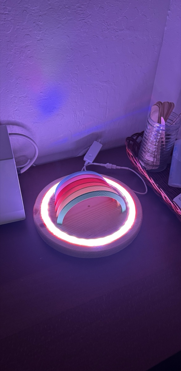 Rainbow Lamp glowing — warm pink and white LED ring illuminates the room